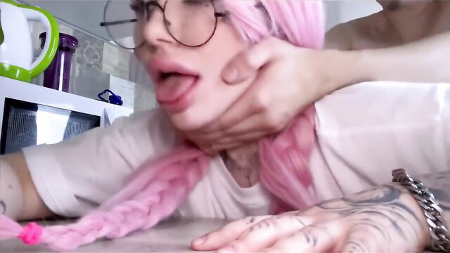 Pink-haired alt girl choked in rough facefuck, tongue out, glasses on