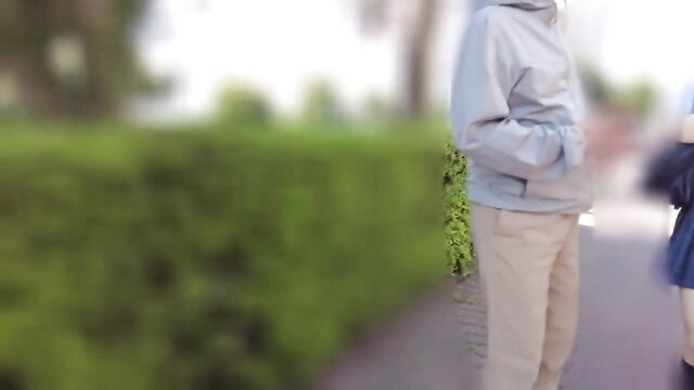 JAV schoolgirl Aya Nogi in uniform with man outdoors by hedge, sdmua-036