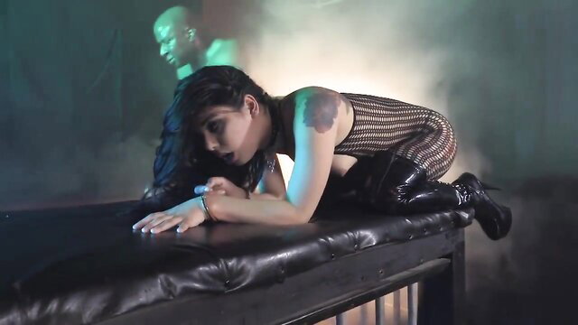 Gina Valentina in fishnet bodysuit and thigh-high boots submission pose