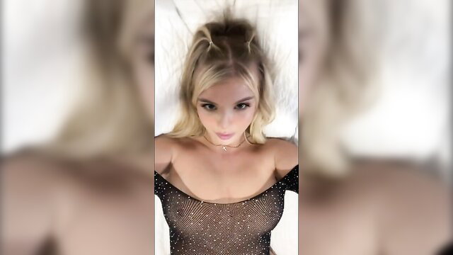 Blonde Layla in sparkly sheer lingerie top, seductive closeup