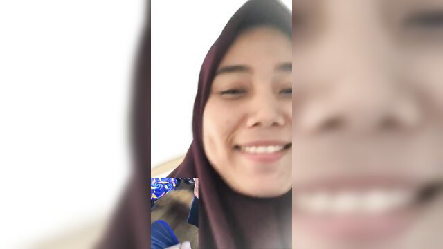 Smiling Indonesian hijab girl closeup selfie, amateur outdoor VCS tease