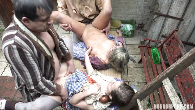 Twisted family kink scene with mature man, blonde woman, child on outdoor mat