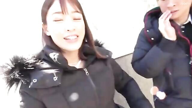 Asian couple in winter coats smiling outdoors, amateur JAV style