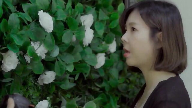 Young Korean sister in black top by white roses, softcore tease