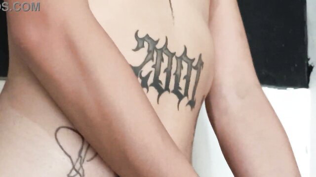 Asian girl with 2001 gothic tattoo on ribs, topless tease