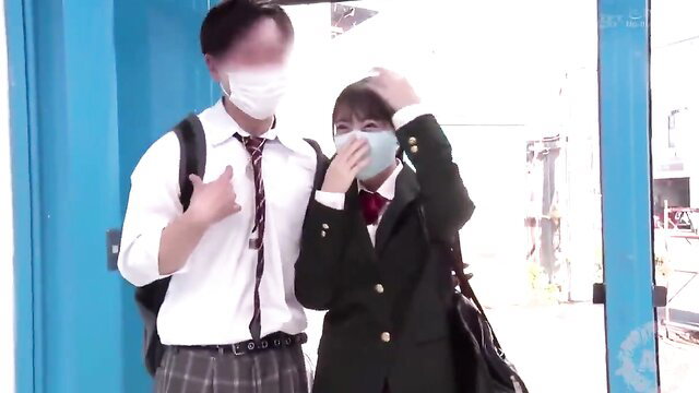 Japanese schoolgirl and boyfriend in uniforms at Magic Mirror game show