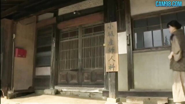 Japanese ancient villager woman in traditional kimono at old house door