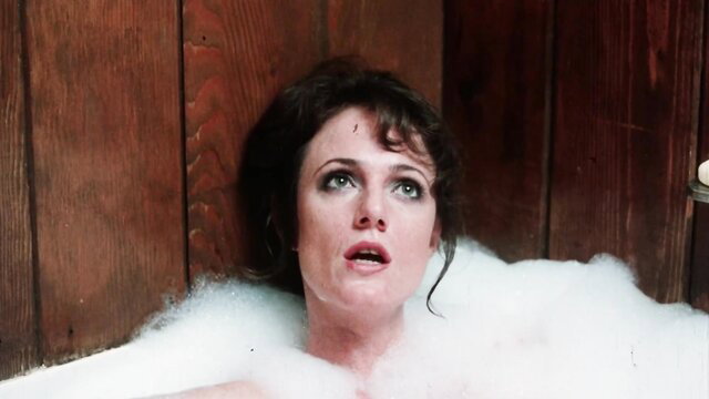 Brunette babe in bubbly bath tub, surprised expression, Taboo II 1982