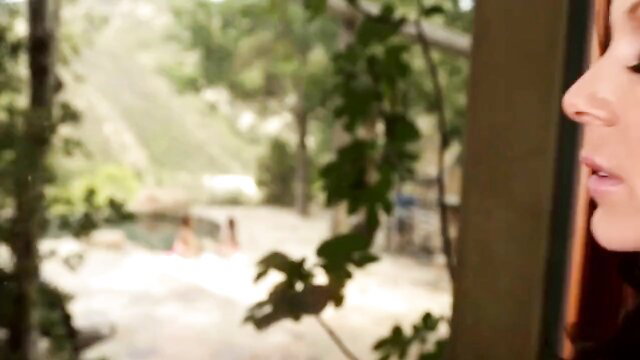 Kendra Lust closeup profile by window, outdoor pool view