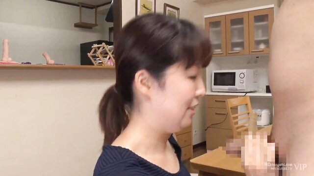 Woman in a kitchen looking at a man's genitals