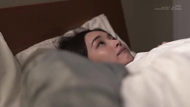 Innocent Japanese mom in bed, seductive gaze in taboo family video