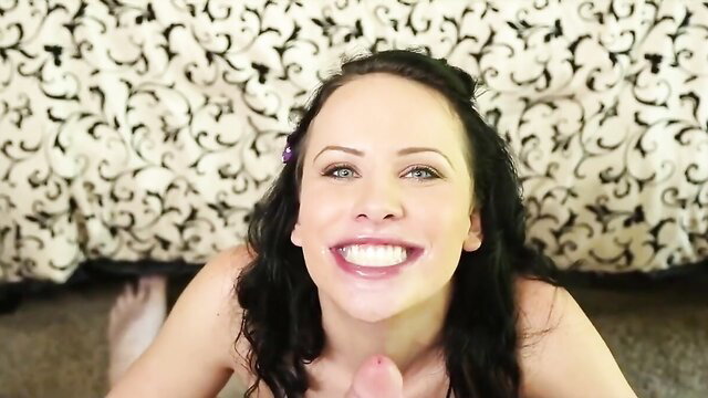 Smiling brunette with green eyes smiles wide, purple hair clip, topless closeup