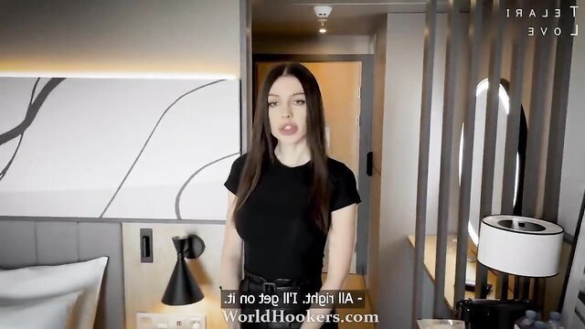 Brunette hotel manager in tight black top and belt smiles seductively