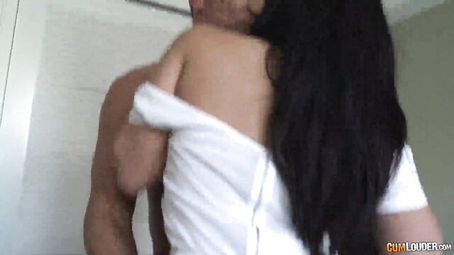 Puerto Rican woman in wet white shirt hugged from behind by man