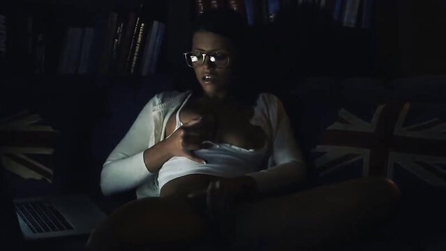 Adriana Chechik in glasses and open cardigan on couch in Blacked BBC scene