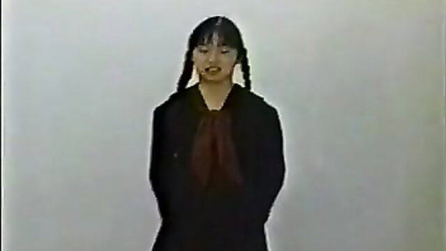 Japanese girl with pigtails in audition, black coat and red tie
