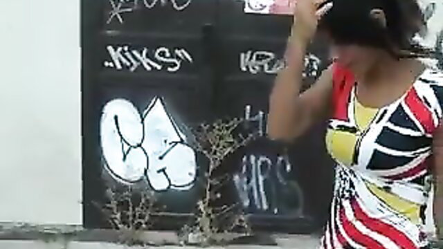 Hot black girl in sexy striped dress by graffiti wall, public tease