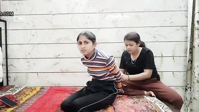 Indian girl hogtied bound on bed by woman in striped top