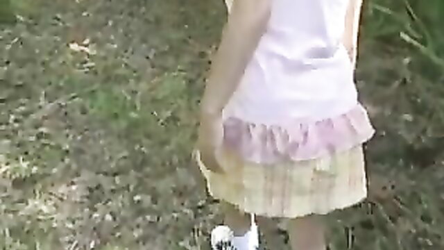Japanese girl in frilly skirt and white top outdoors, big tits tease