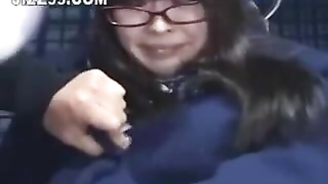 Asian schoolgirl with glasses kissed by geek on bus