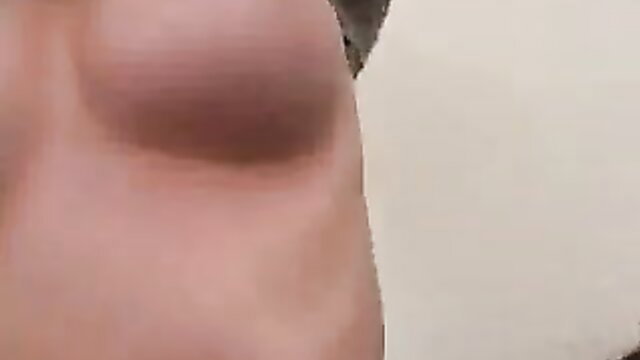 Closeup of woman's nude breast and torso in ex-gf handjob video