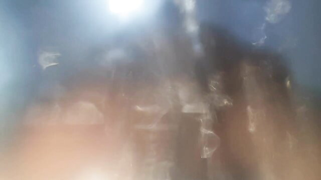 Blurry women pissing over man in golden shower fetish scene