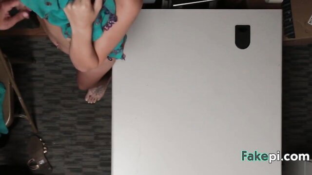 Bella Rose in green floral top, bare feet over desk in hot tease