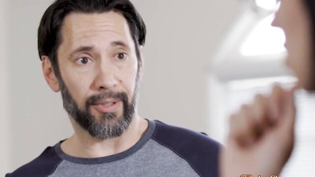 Tommy Pistol with wide eyes as brunette babe teases him at work