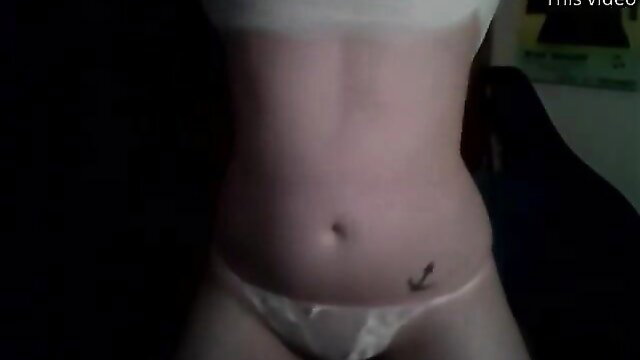 Slim Asian woman in white panties showing navel tattoo closeup