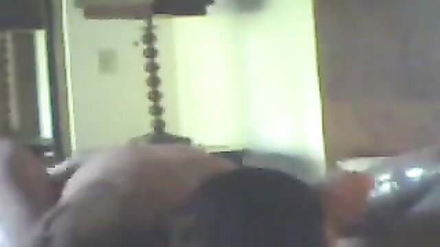 Blurry hidden cam motel video of nude Asian woman lying on bed