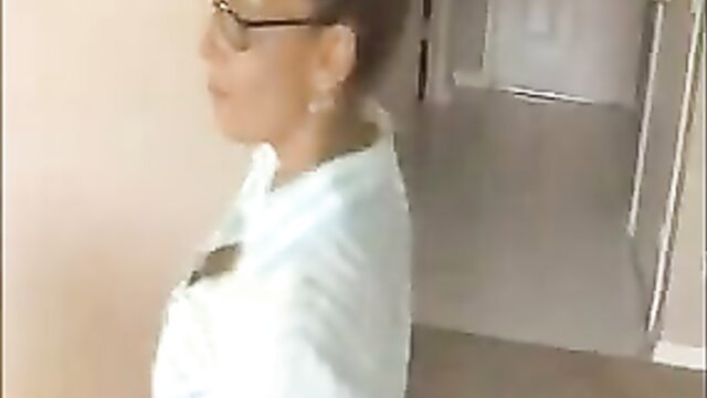 Curious Asian MILF in white blouse turns seductive in hallway