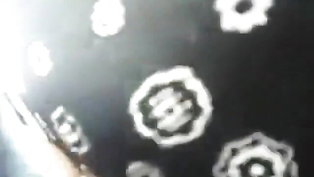 Blurry closeup of white flower pussy outlines on black in adult video thumbnail