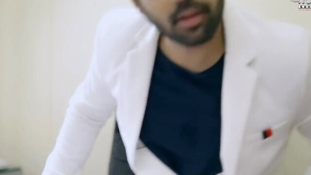 Handsome Indian man in white blazer and dark shirt, intense close-up gaze