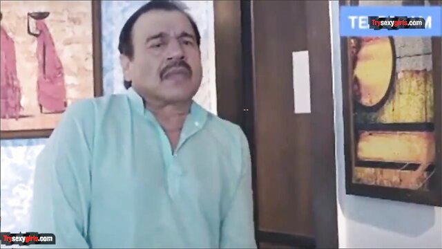 Mature Indian man in light blue kurta, intense lustful gaze