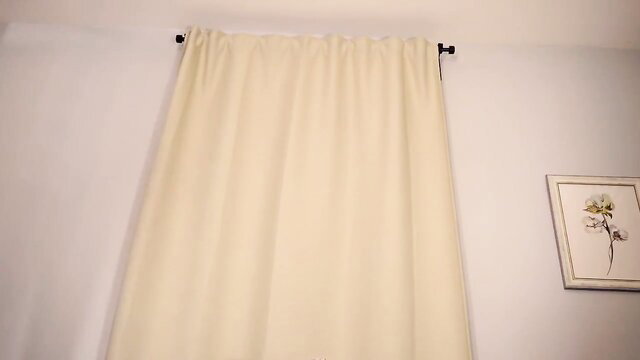 Cream curtains and flower art in bedroom softcore setup