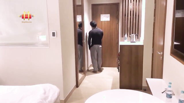 Indian man in hotel room mirror, black top gray pants