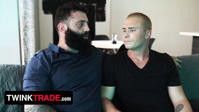 Bearded hunk bear cuddles shaved-head twink on couch in hot foursome preview