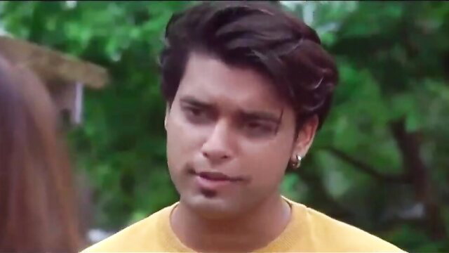 Handsome Indian man with long hair in yellow shirt from Charmsukh Ullu web series