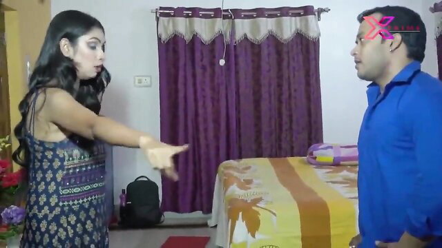 Indian wife in printed dress argues with husband in bedroom