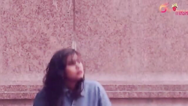 Indian beauty in blue shirt with wavy dark hair, seductive gaze