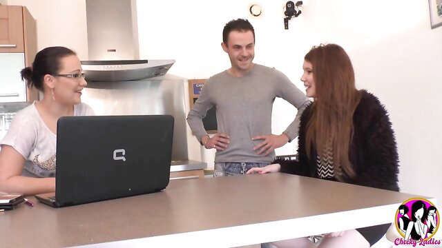 Brunette teen with friend chats with guy over laptop at kitchen table