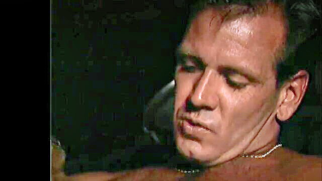 Muscular man with necklace in dim-lit closeup, Tabitha & Kimberly reunion