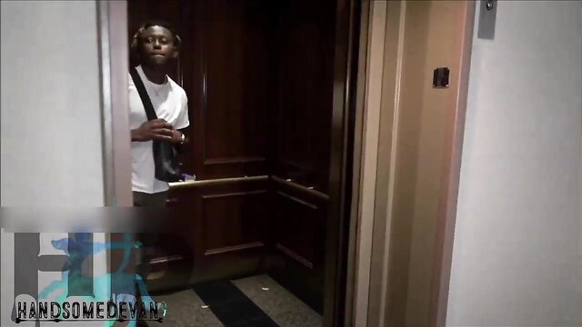 HandsomeDevan enters elevator with black shoulder bag