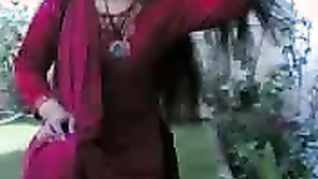 Chunky Indian MILF brunette wife in red saree showing cleavage outdoors