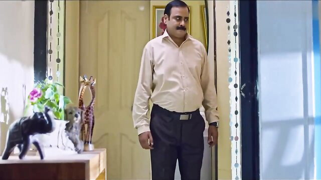 Indian man in shirt pants stands by door in cheating wife video thumbnail