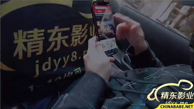 Asian woman watches JAV porn on phone in car, sexy casual wear