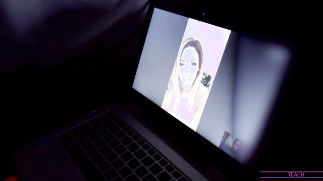 Nina Skye face closeup on laptop screen in dark room webcam view