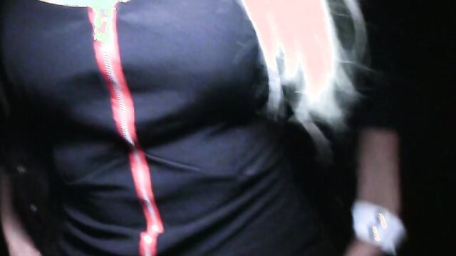 Slim blondie in tight black zip dress, pale skin, long white hair, public tease