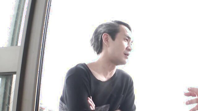 Handsome Asian man in black top at cuckold wife photoshoot