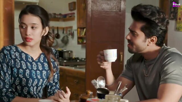 Indian woman and man having a romantic moment in a kitchen